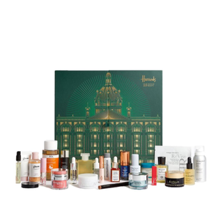harrods beauty advent calendar with products laid out in front of green box with harrods store design