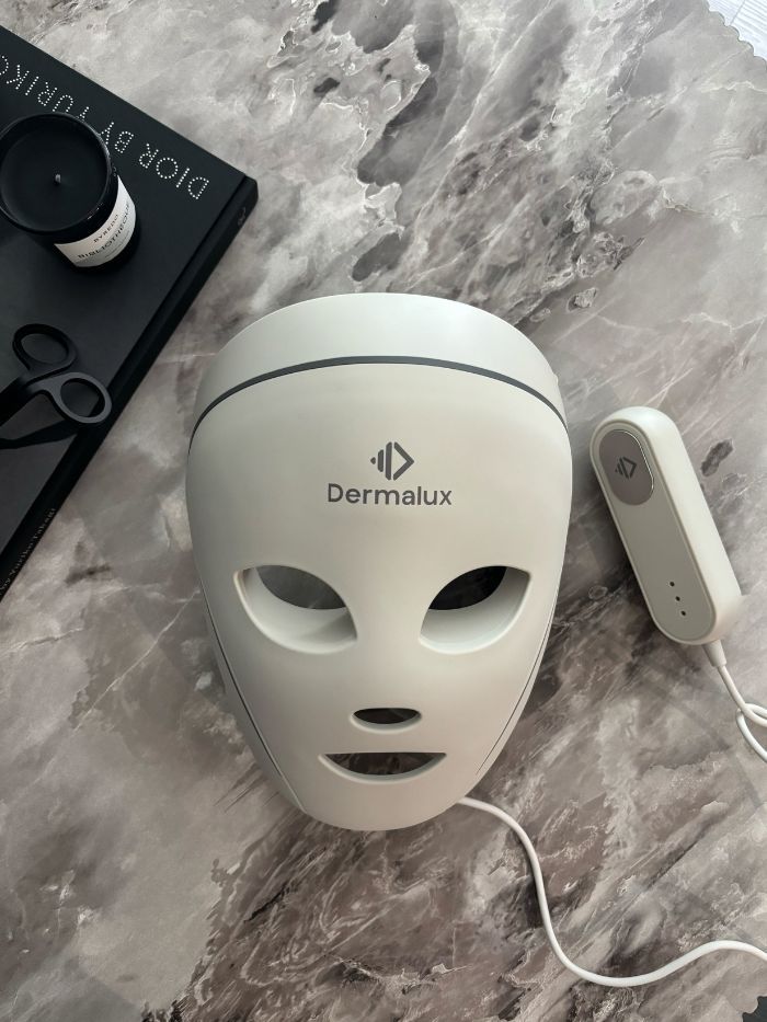The Dermalux LED Face Mask on a marble table