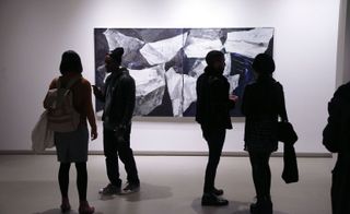 people standing in a gallery