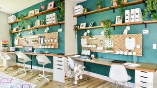 rustic wooden double IKEA desk hack in front of a green wall with rustic shelving