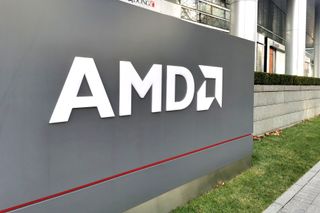 AMD logo on a gray sign outsode one of it soffice buildings, with the building in the background