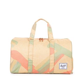 Herschel Novel Duffle in Natural Portel bag with abstract pattern with pastel shapes