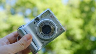 The Canon PowerShot A540 held in a person's hands outdoors