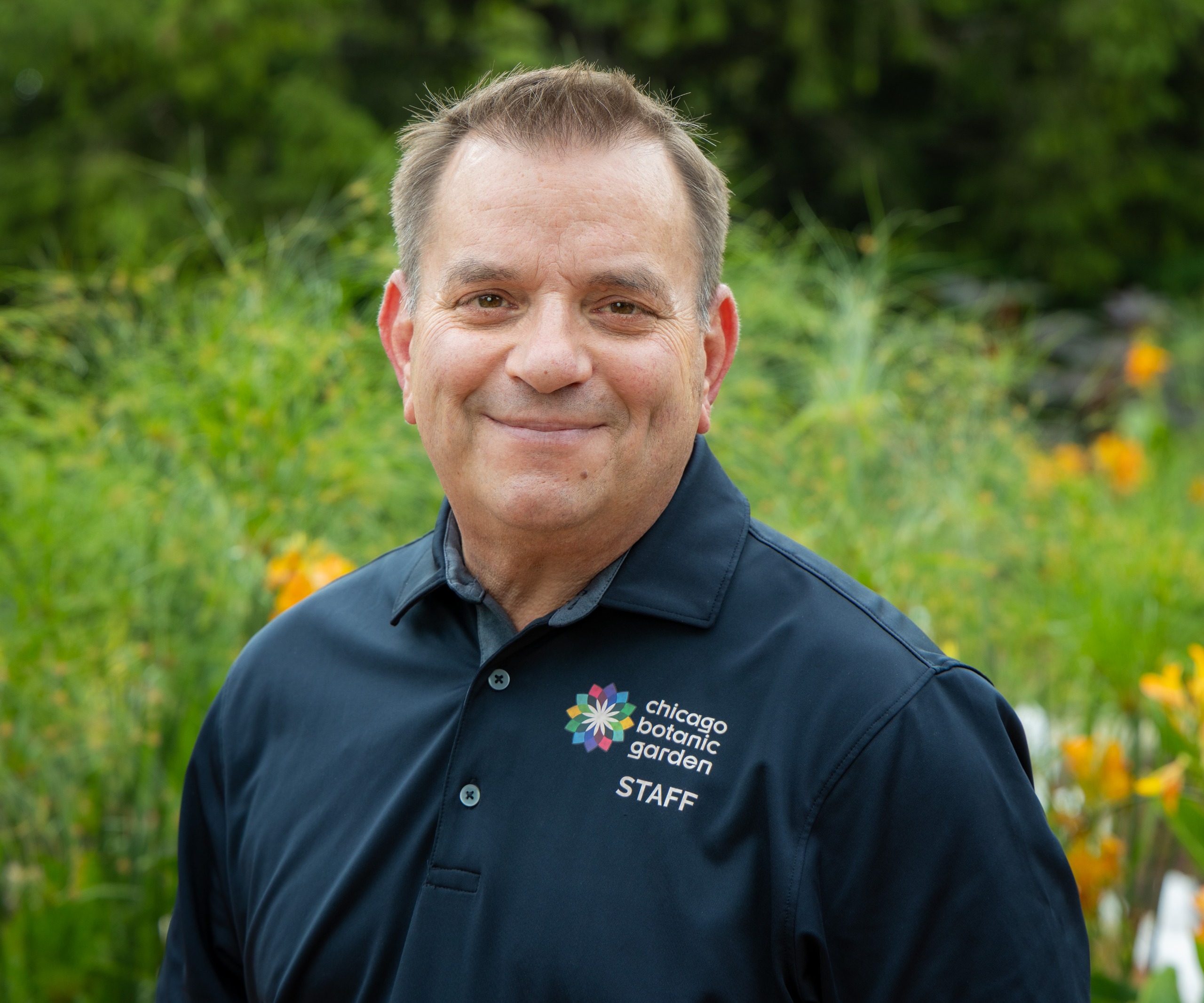 Tim Pollack wearing staff uniform smiling to camera