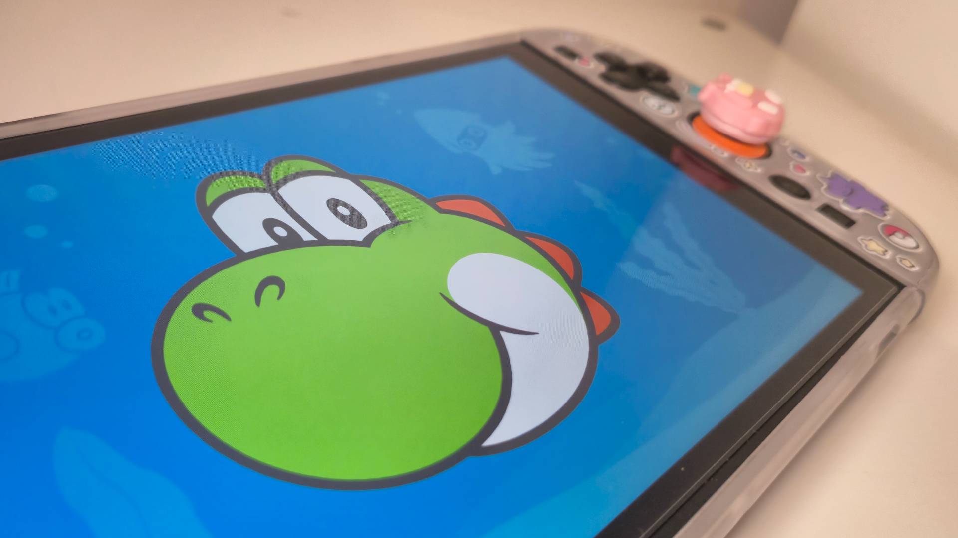 Photo of Hello, Yoshi! running on a Nintendo Switch 2 that's laying on a white desk.