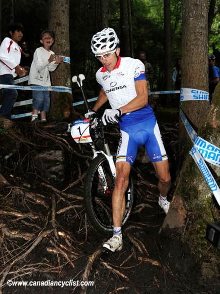 Julien Absalon (Orbea) makes his way over slippery roots.