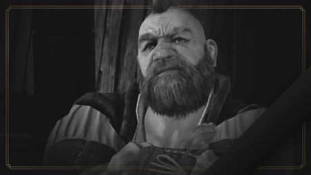 Black-and-white screenshot from The Witcher 3 of Zoltan Chivay with his arms crossed. The dwarf character has a big bushy beard and small spiky mohawk. The edge of the image is outlined by a thin gold frame.