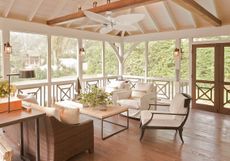 sunroom/porch with wooden flooring neutral sofas and chairs 