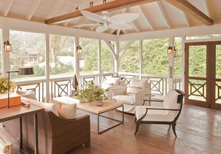 sunroom/porch with wooden flooring neutral sofas and chairs