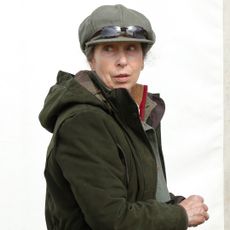 Princess Anne wearing a green coat and flat cap