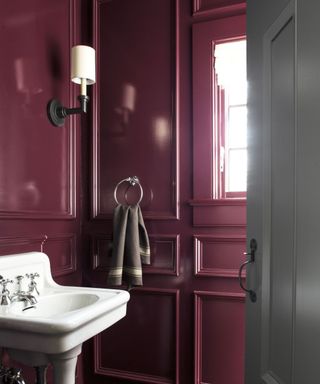 powder room painted dark purple in gloss paint