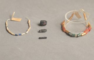 Ancient iron beads (center) excavated from an Egyptian tomb in 1911 were made from iron meteorites.