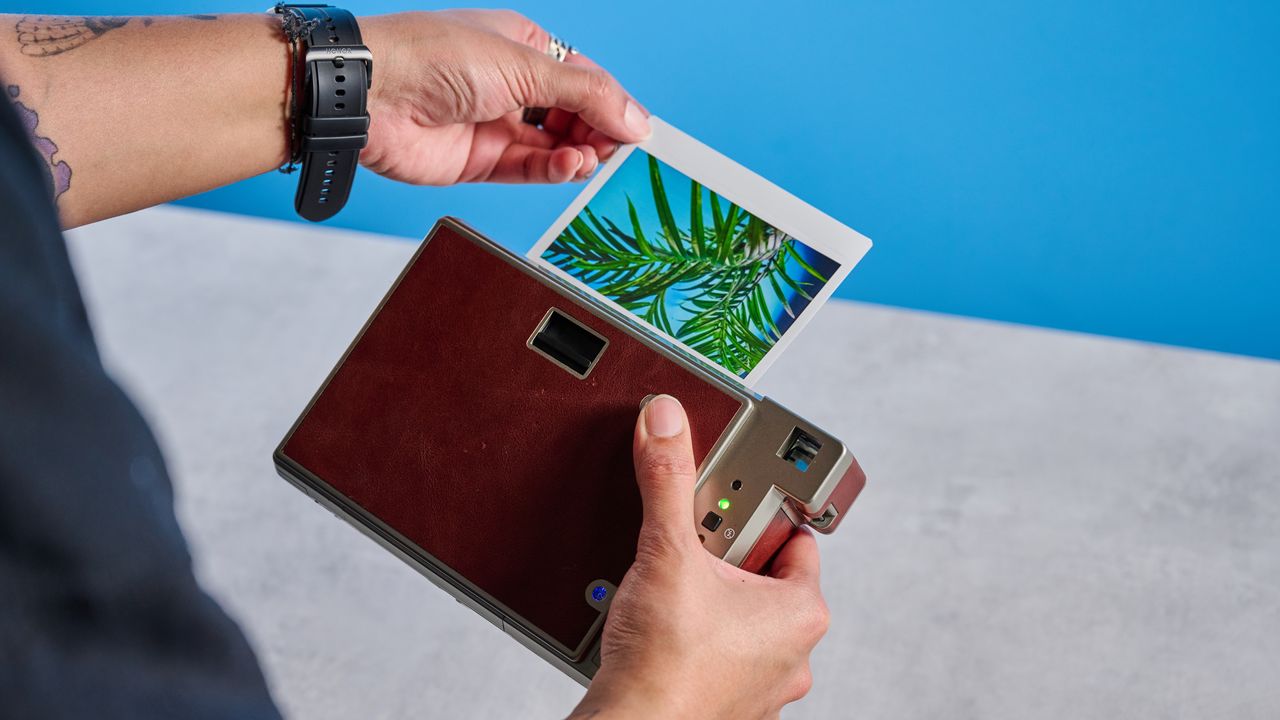 A brown Lomography Lomo'Instant Wide Glass instant camera