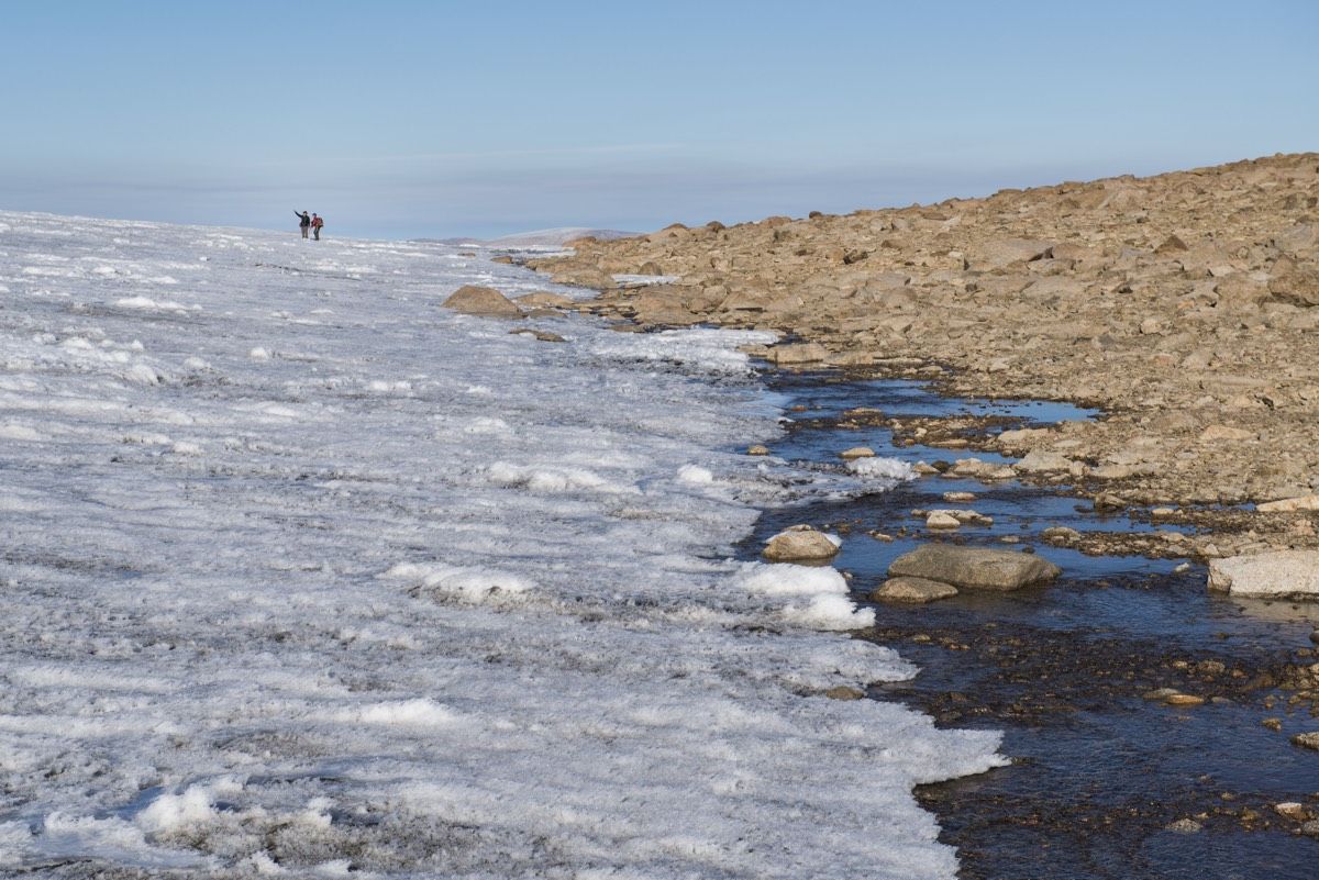 At the boundary of ice and rock on Baffin Island in the Canadian Arctic, scientists from the University of Colorado Institute of Arctic and Alpine Research confer. 