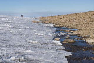 At the boundary of ice and rock on Baffin Island in the Canadian Arctic, scientists from the University of Colorado Institute of Arctic and Alpine Research confer.