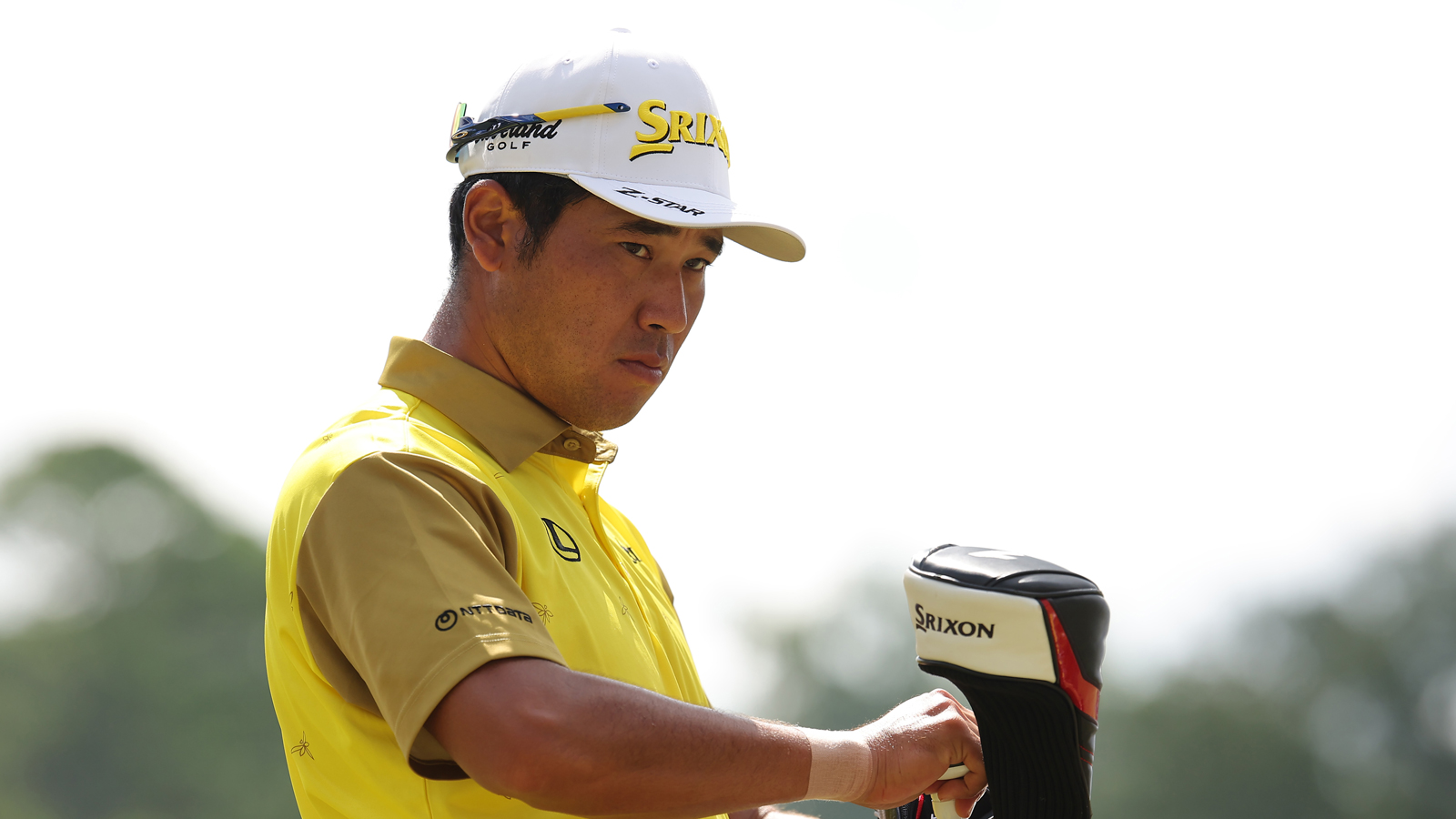 Hideki Matsuyama adjusts his driver