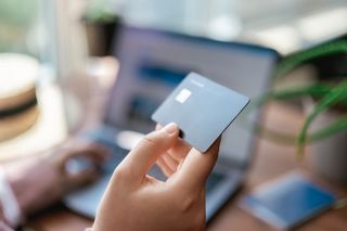 A person using their credit card for an online purchase.