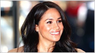 Meghan Markle smiles in nude lipstick as she attends the WellChild awards at the Royal Lancaster Hotel on October 15, 2019 in London, England.