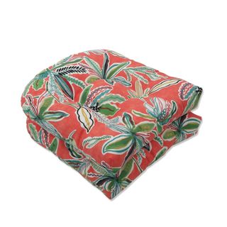 Two coral curved seat cushions with spiky green leaf illustrations with white borders