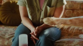 A shot of a dog's paw stroking a womans arm