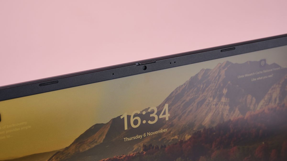 Close-up of webcam on Asus V16 with pink wall in background