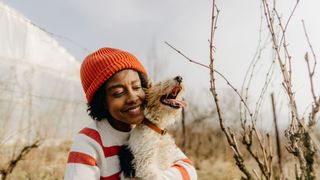 Woman holding a dog smiling