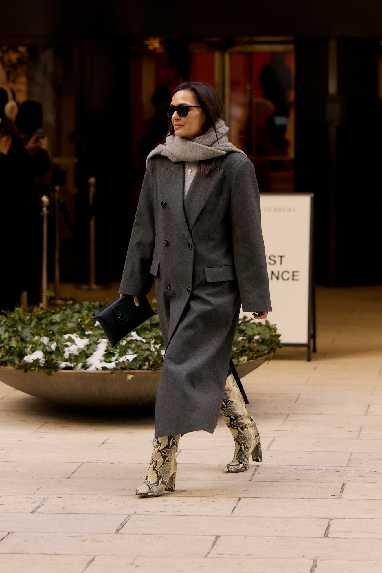 Woman in snakeskin boots.