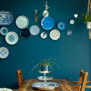 dining room with dishes on blue wall