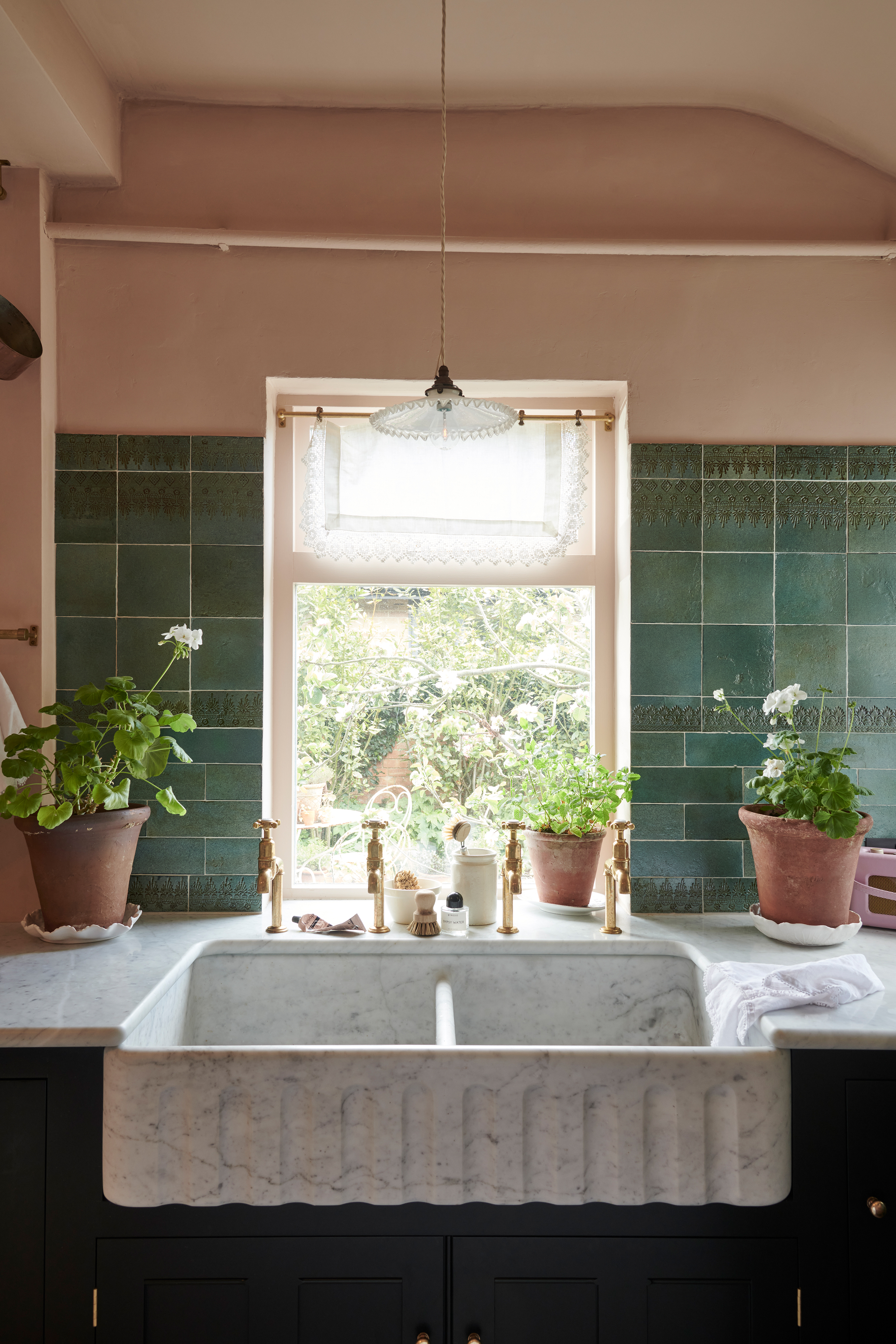 Vintage marble kitchen sink with four gold taps