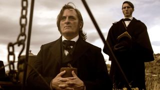 (L to R) Kim Coates as Brigham Young and Alex Breaux as Wild Bill Hickman in Episode 102 of "American Primeval."