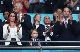 LONDON, ENGLAND - JULY 11: Catherine, Duchess of Cambridge, Prince George of Cambridge and Prince William, Duke of Cambridge and President of the Football Association applaud during the UEFA Euro 2020 Championship Final between Italy and England at Wembley Stadium on July 11, 2021 in London, England. (Photo by Eddie Keogh - The FA/The FA via Getty Images)
