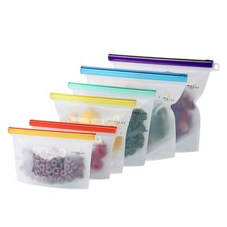 Six silicone bags with colorful strips and fruit in them
