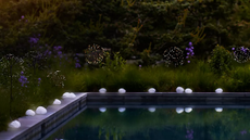 a pool with solar pebble lights around it