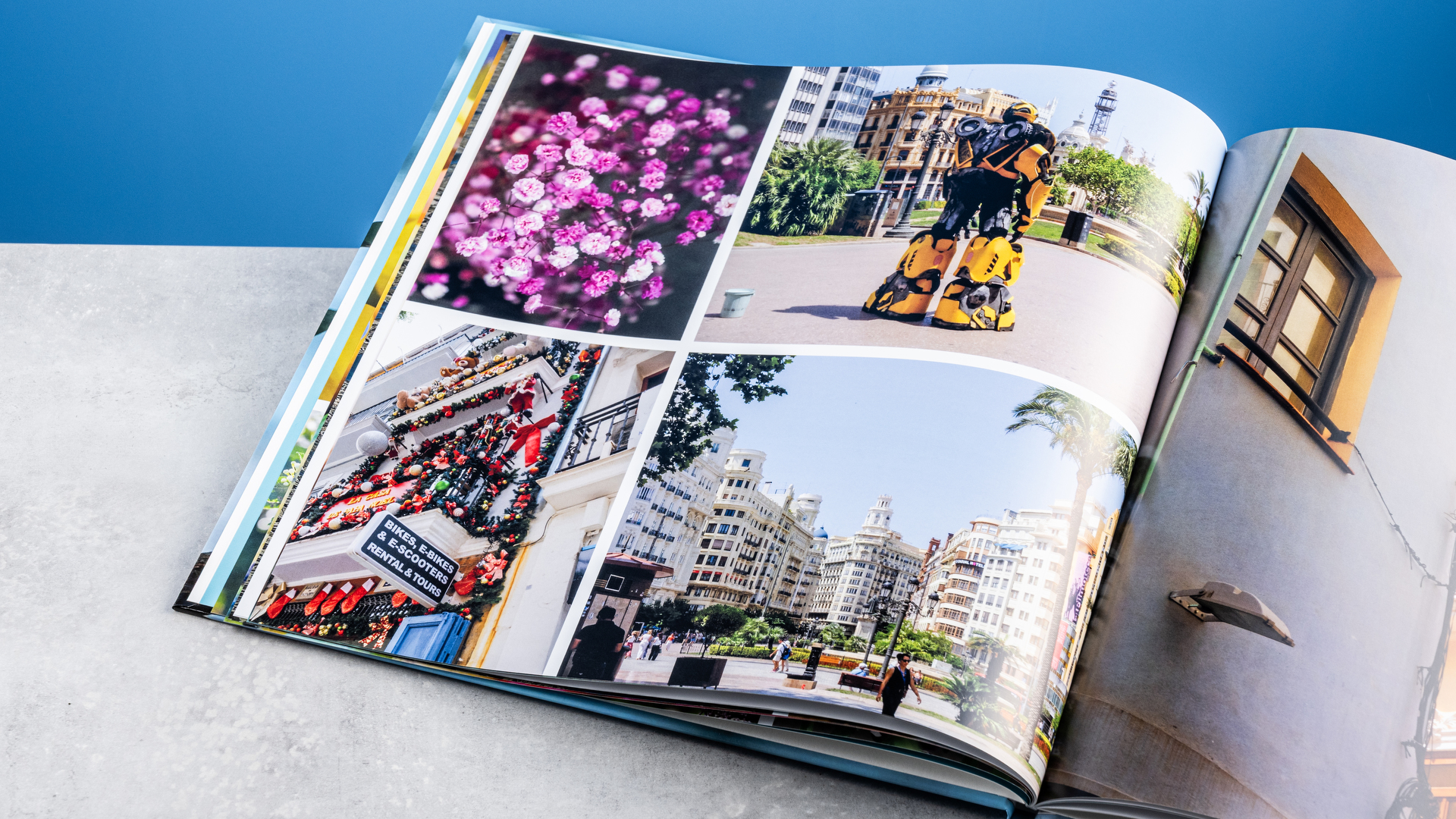 Vistaprint photo book pages photographed on a table in front of a blue background