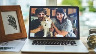 Couple and their cat having a video call