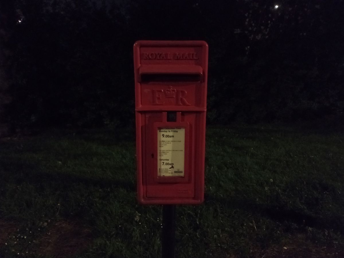 Moto G22 camera sample showing a postbox at night