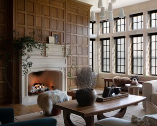 Fall decor ideas, traditional, cozy living room with wooden paneling, stone fireplace, seating