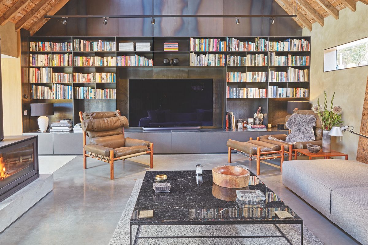 dark living room in barn conversion with tv and bookcase