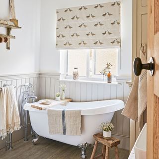 Rustic style bathroom with white clawfoot bathtub