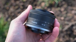 Canon RF-S 10-18mm lens held in a hand