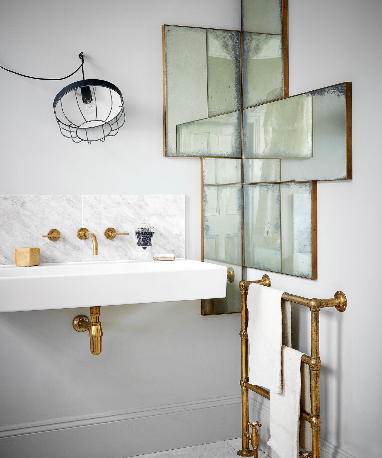 White bathroom with sink and mirrored wall