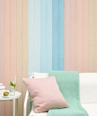 garden fence painted in multiple pastel shades for an ombre effect