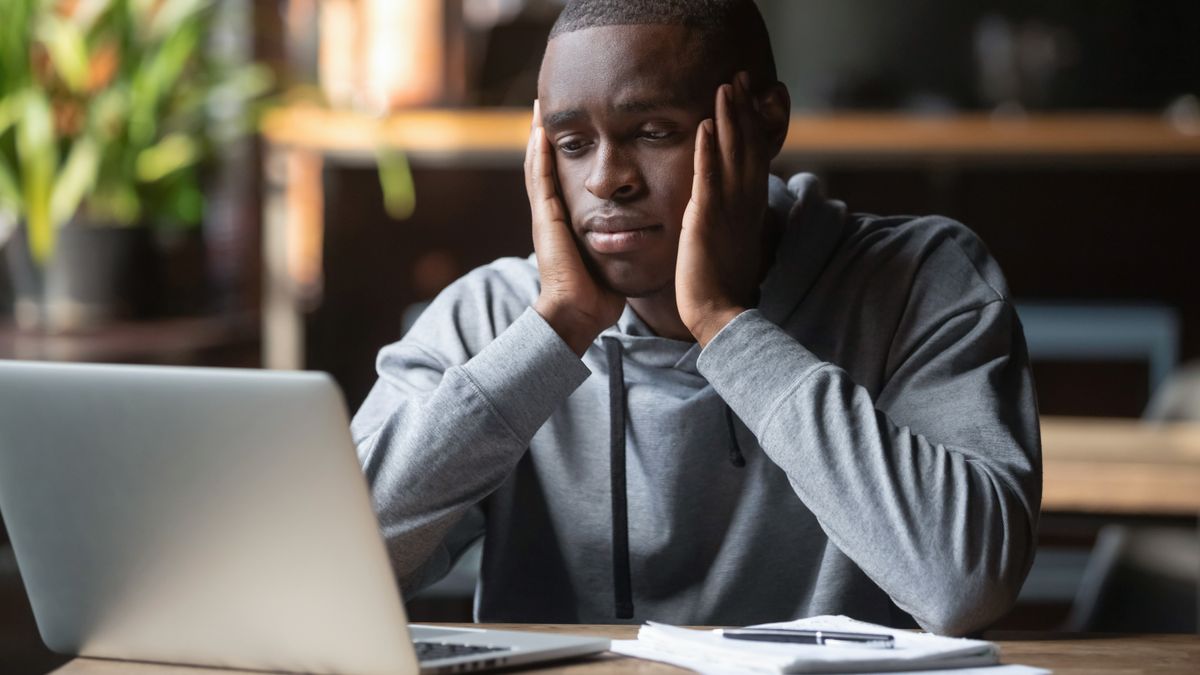 Frustrated man at laptop