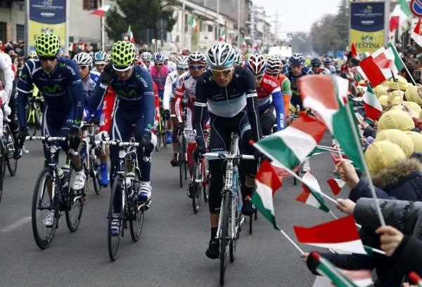 Italian school children wave off the riders