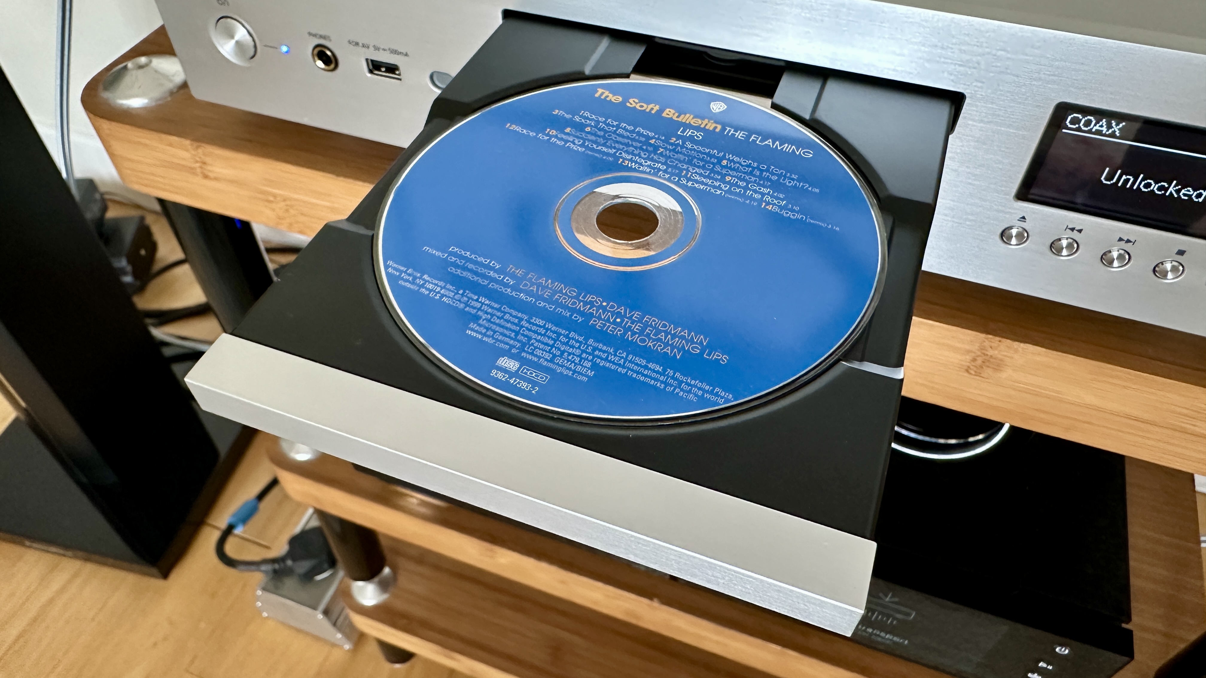 An HDCD being loaded into the Technics SL-G700M2, in a hi-fi listening room