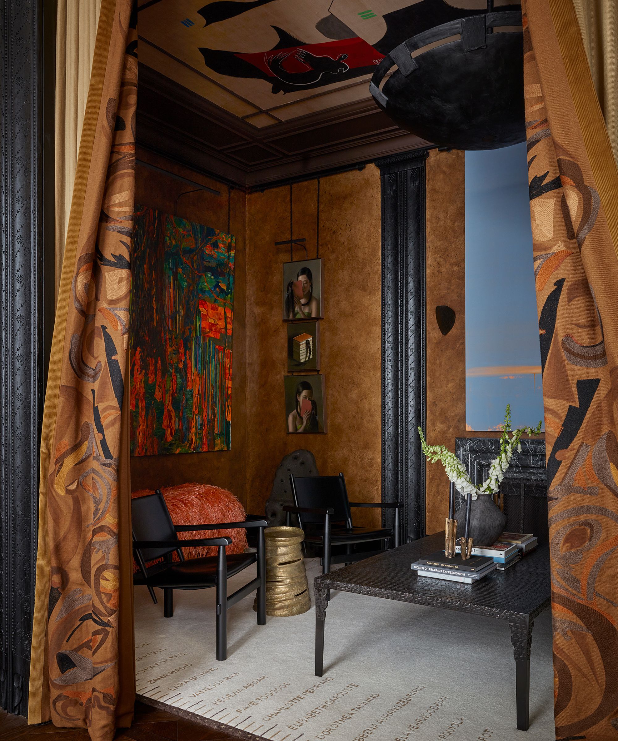 A room with textured walls and black furniture