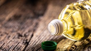 bottle of vegetable oil on a wooden surface