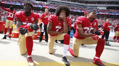 Colin Kaepernick takes the knee