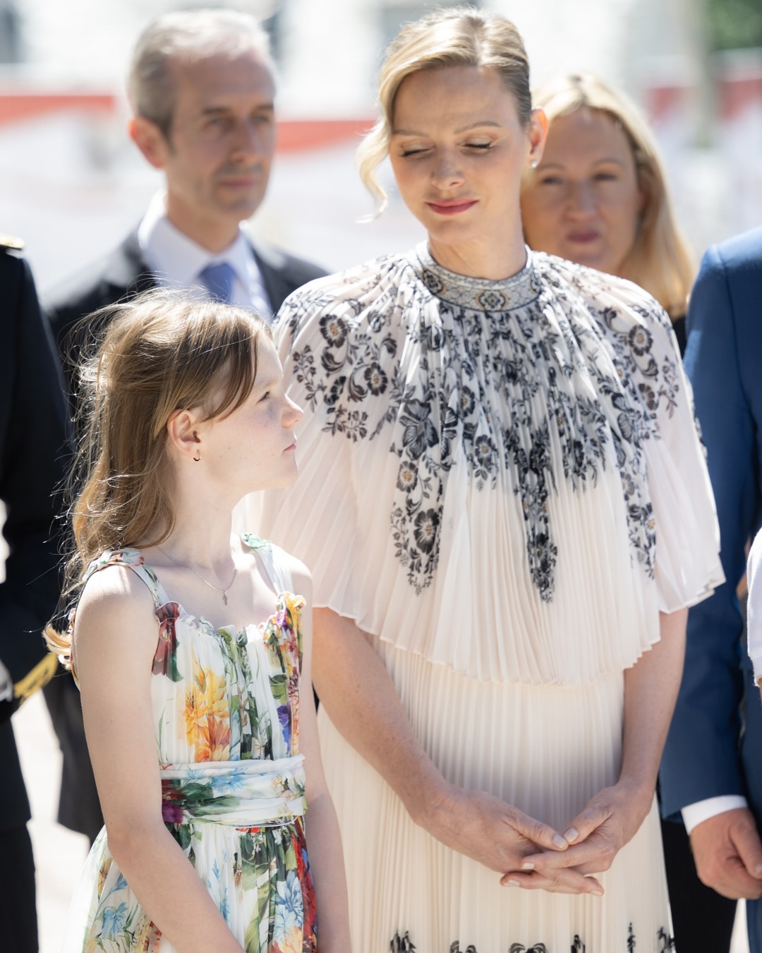 Princess Charlene and Princess Gabriella wearing white floral dresses