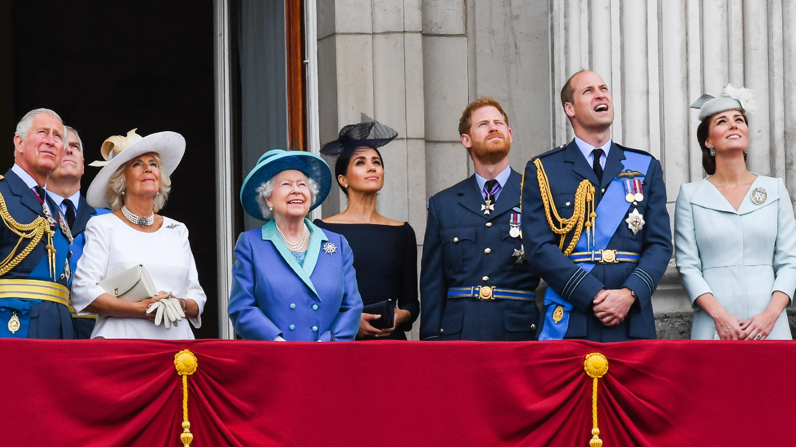 Prince Charles, Prince of Wales, Camilla, Duchess of Cornwall, Prince Andrew, Duke of York, Queen Elizabeth ll, Meghan, Duchess of Sussex, Prince Harry, Duke of Sussex, Prince William, Duke of Cambridge and Catherine, Duchess of Cambridge stand on the balcony of Buckingham Palace to view a flypast to mark the centenary of the Royal Air Force (RAF) on July 10, 2018 in London, England.